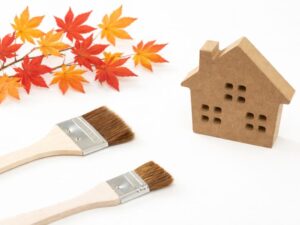 鮮やかに色づいた紅葉と家のオブジェと刷毛